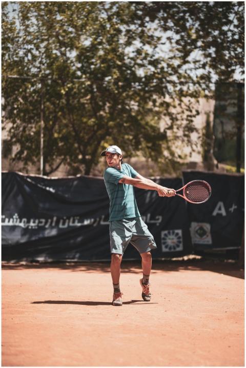 Tennis player in action with a powerful swing on a