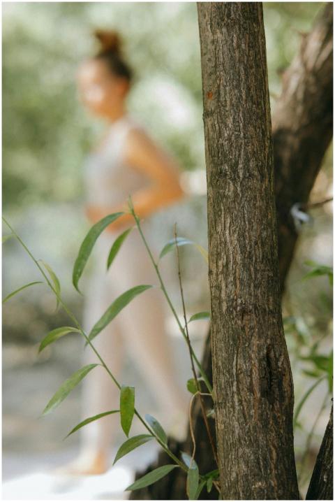 A woman practicing yoga outdoors, blending serenit