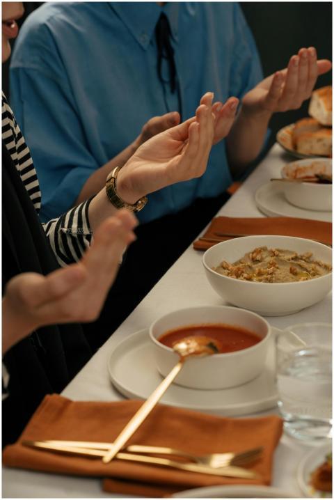 People praying before a meal during Ramadan, symbo