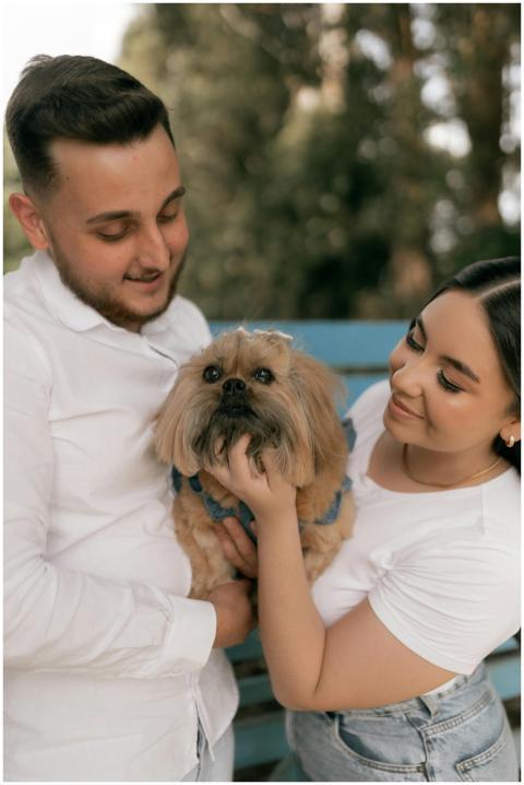 A loving young couple holding their adorable Pekin