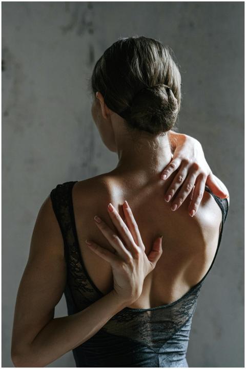 Back view of a woman stretching with hands behind