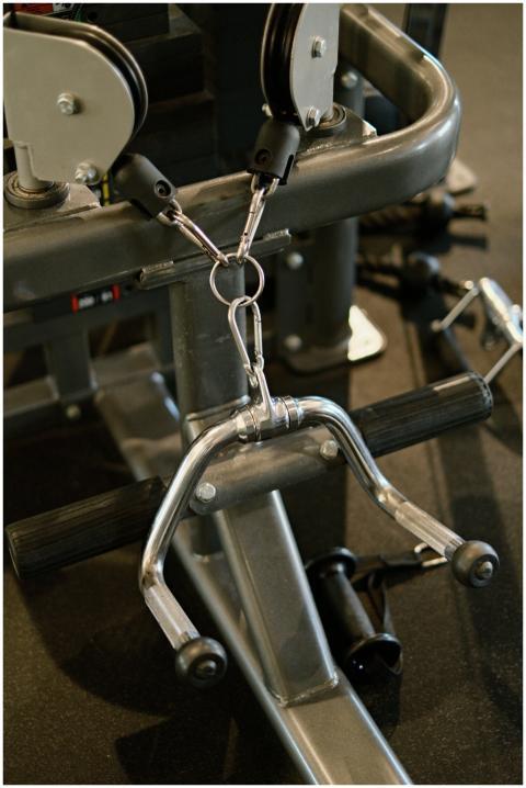 Detailed view of exercise machine showing cables a