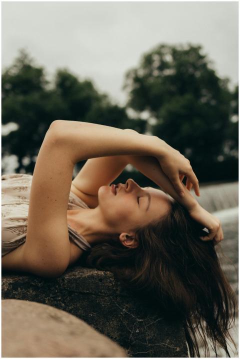 A peaceful woman with eyes closed lying gracefully