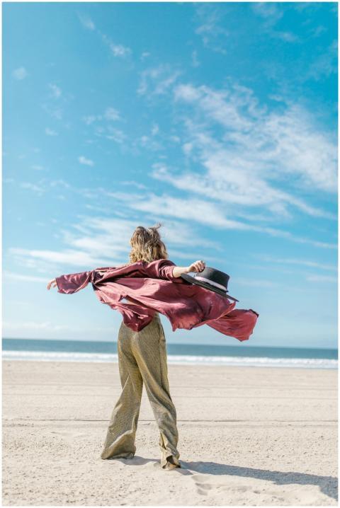 A joyful person embracing the freedom of a sunny d