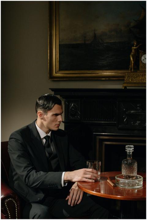 Stylish man in suit seated indoors, captures a ret