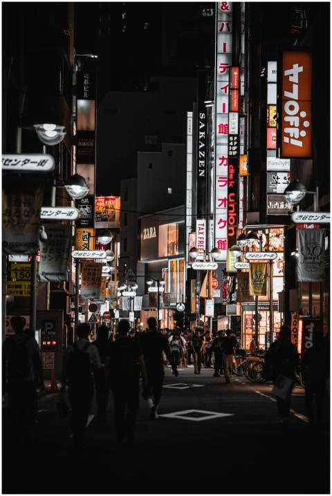 A vibrant night scene captures the bustling street