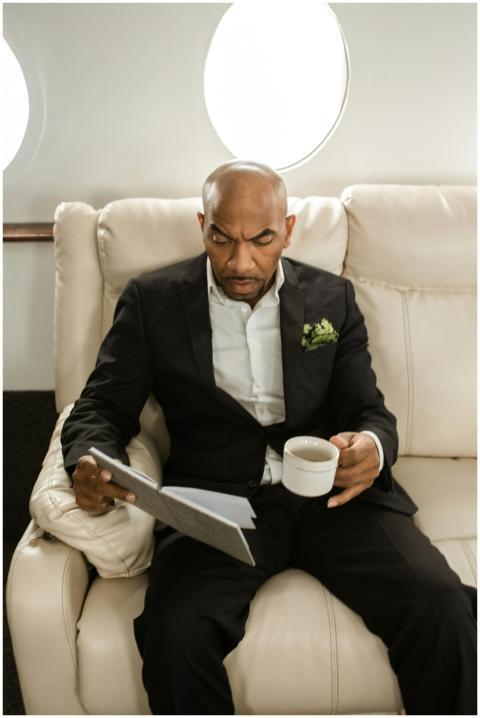 Businessman in a black suit reading documents and