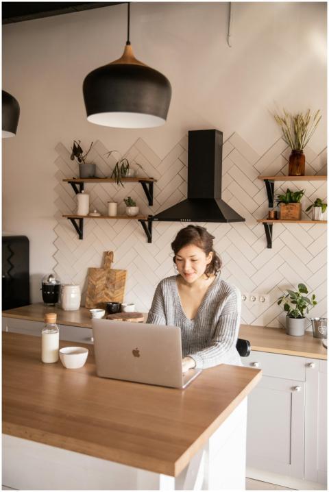 Focused woman in casual outfit sitting at counter