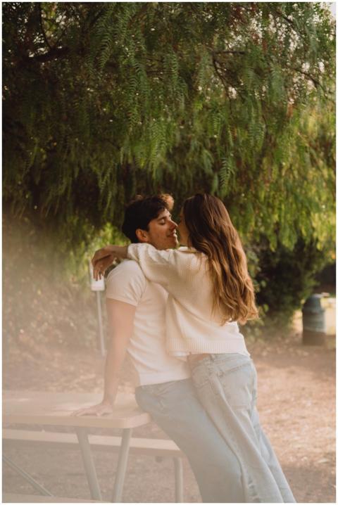 A young couple sharing a loving embrace outdoors u