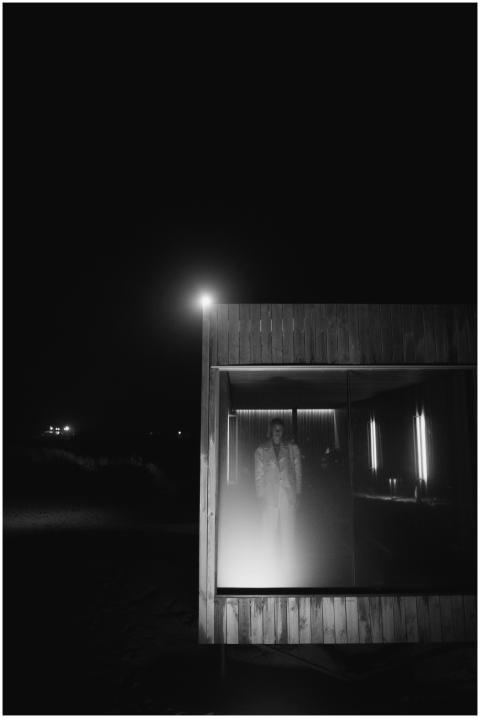 A striking monochrome image of a person standing i