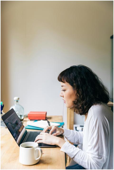 Side view of concentrated young female freelancer