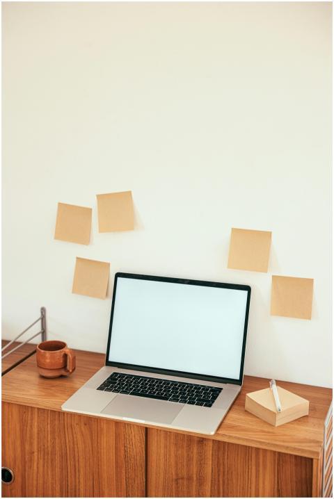 Minimalist workspace with laptop and sticky notes