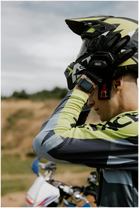 Close-up of motocross rider adjusting helmet befor