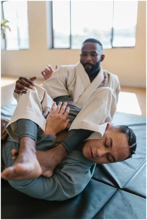Two men practicing martial arts in a gym, focusing