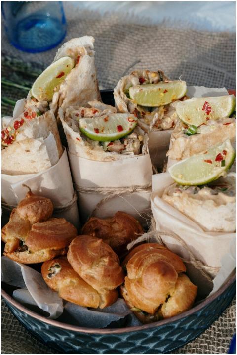 A tempting display of wraps with lime wedges and p