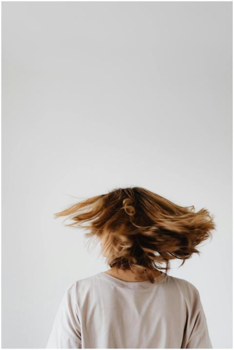 A woman with long hair swirling around, captured f