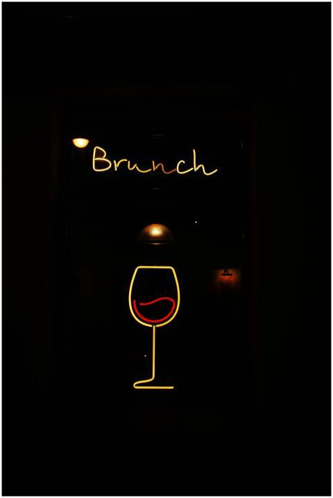 Vibrant neon brunch sign featuring a stylish wine