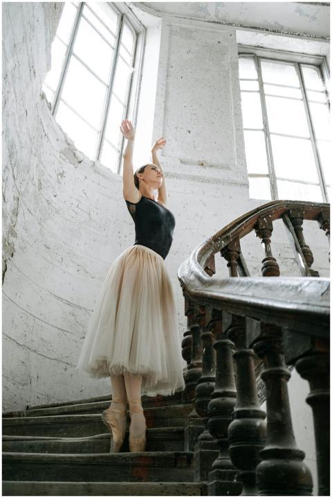 A ballerina practices gracefully on a vintage spir