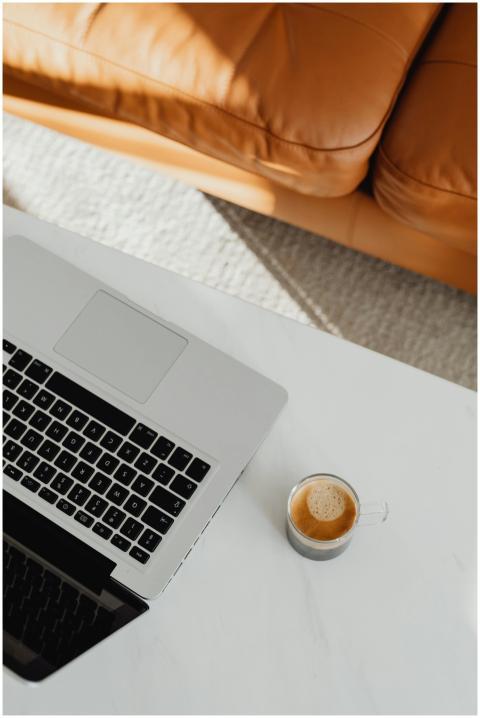 Top view of a neat workspace with a laptop and cof