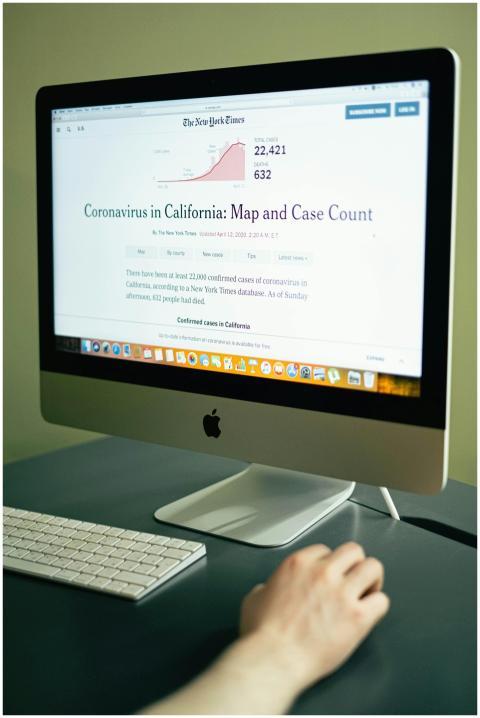 A computer displaying coronavirus case numbers in