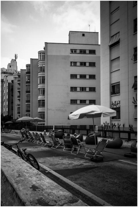 Black and white view of urban lounge area with umb