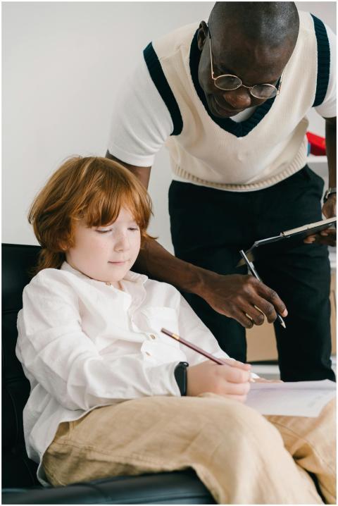 A tutor helps a child with homework during a learn