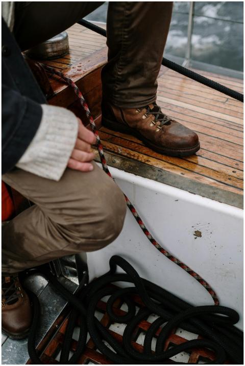 Close-up of a crew member standing on a yacht deck