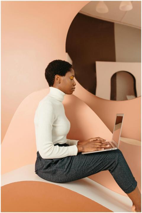 Stylish woman working on a laptop in a modern indo