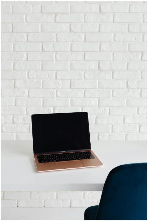 A sleek modern workspace featuring a laptop on a w