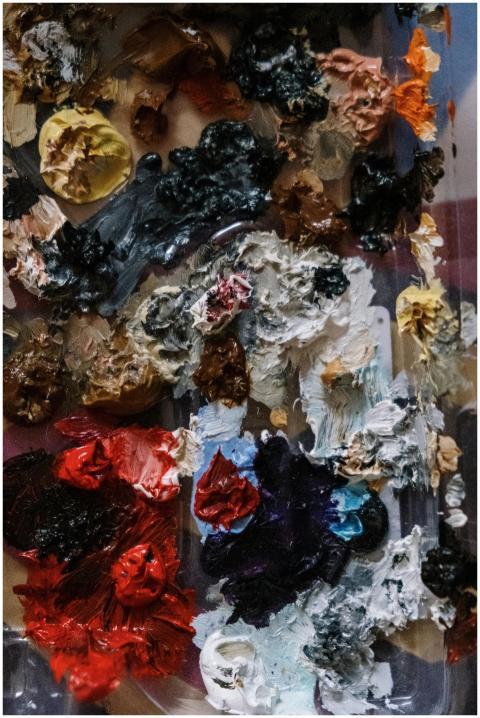 Colorful close-up of a mixed oil paint palette wit