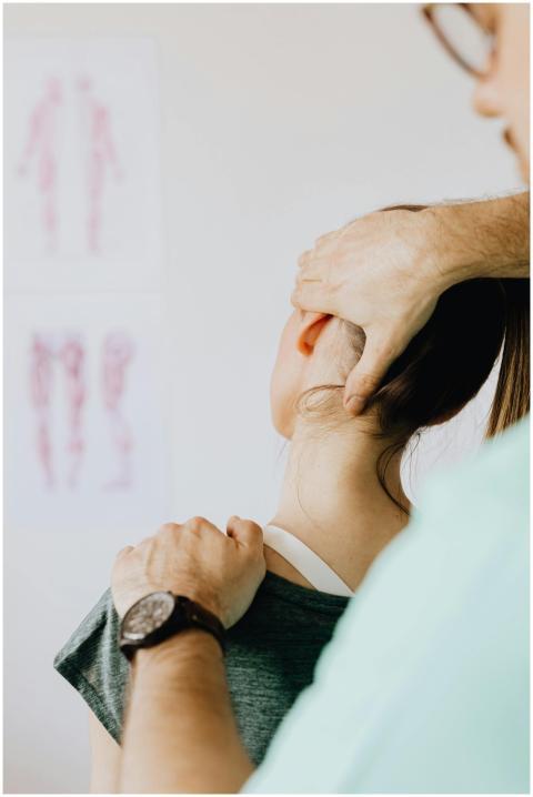 A female patient receives a chiropractic neck adju