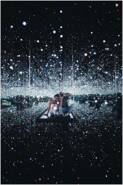 A couple enjoying a captivating infinity mirror ro