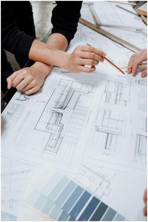 Architects discussing detailed blueprints and sche