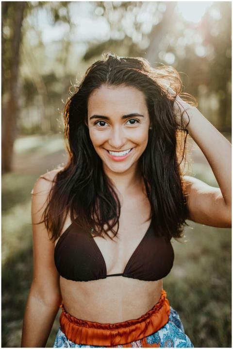 Carefree woman in bikini enjoying sunny day outdoo