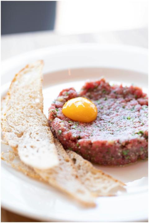 Savory beef tartare dish with raw egg yolk served