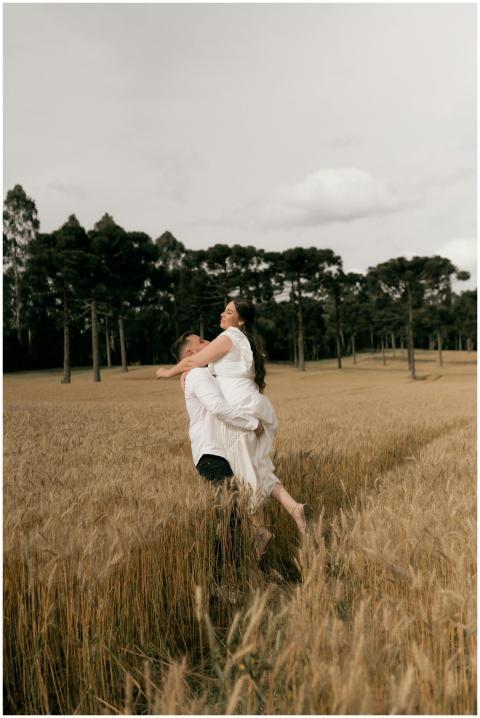 A loving couple in a wheat field, symbolizing roma