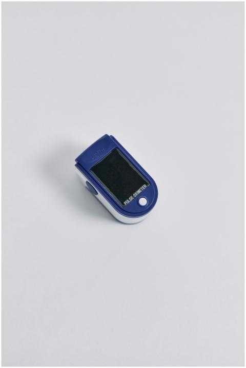 High-quality image of a blue pulse oximeter on a w