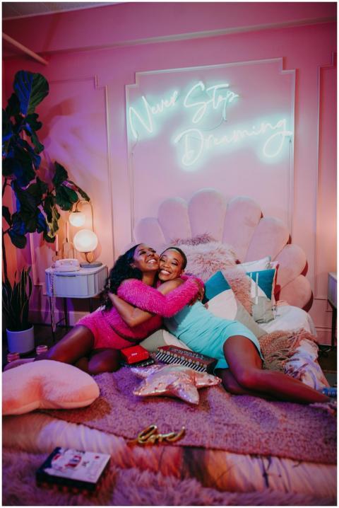 Two girls having fun in a colorful bedroom during