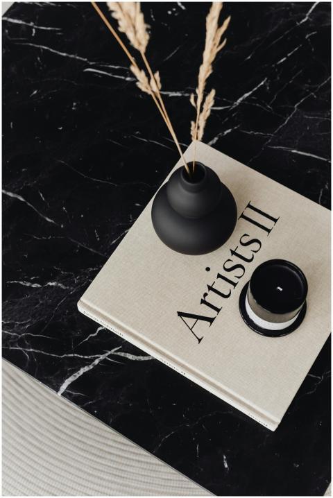 Flat lay of a black vase and minimalist book title