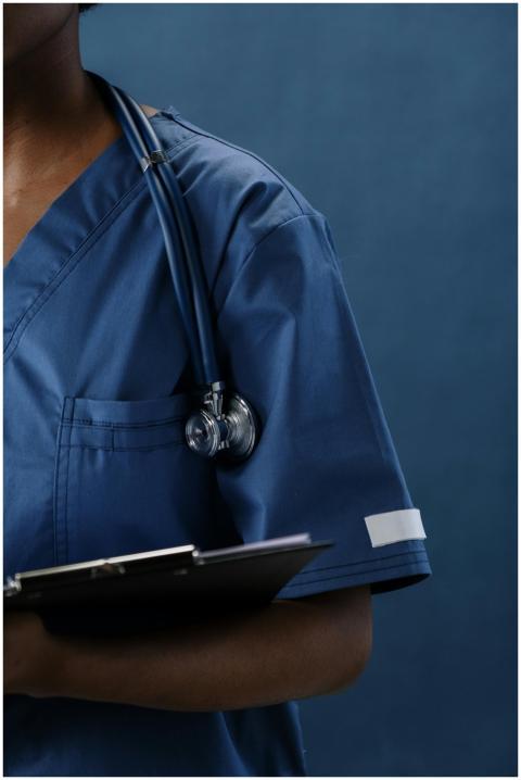 Close-up of a healthcare professional in blue scru