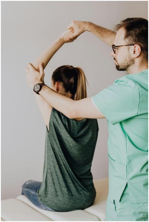 Crop osteopath in eyewear and uniform with wristwa