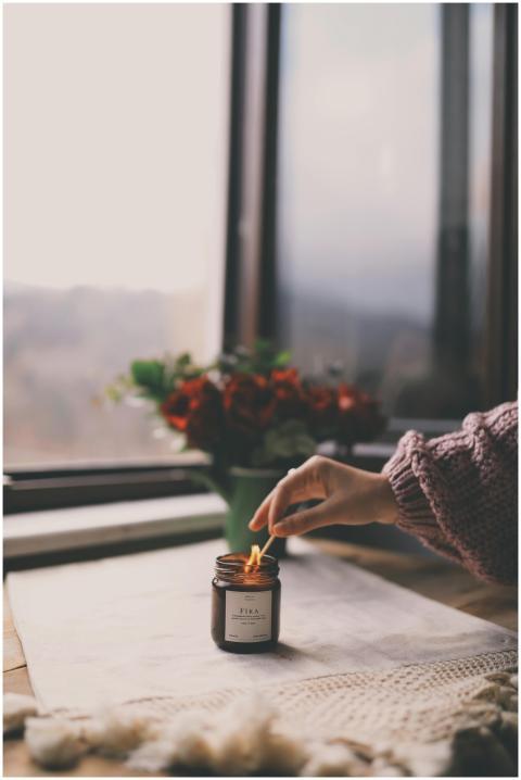 Warm and cozy indoor setting with a lit candle, sw