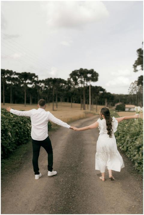 Joyful couple walking outdoors holding hands on a