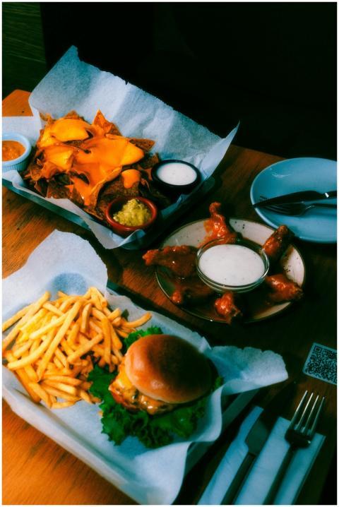 An appetizing spread featuring burgers, nachos, an