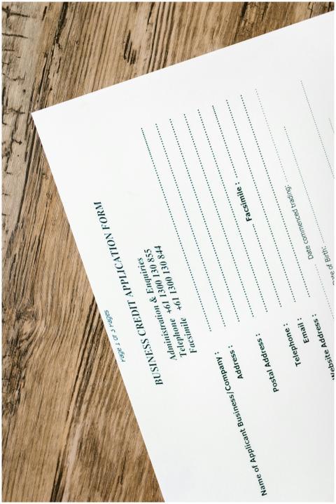 A business credit application form resting on a ru