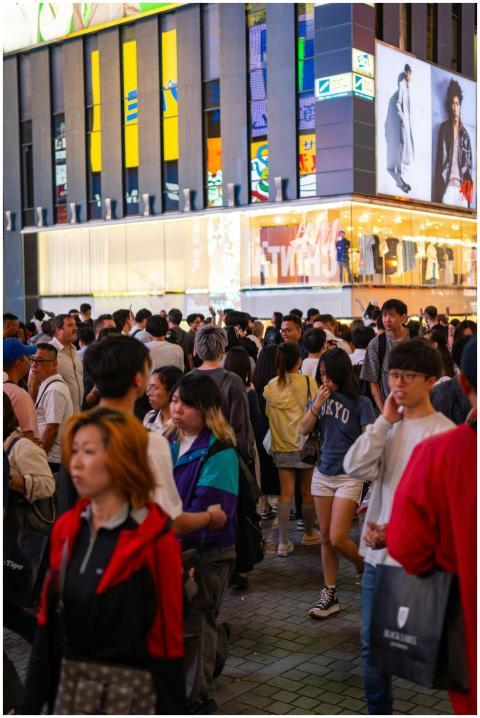 Lively street scene with diverse crowd at a bustli