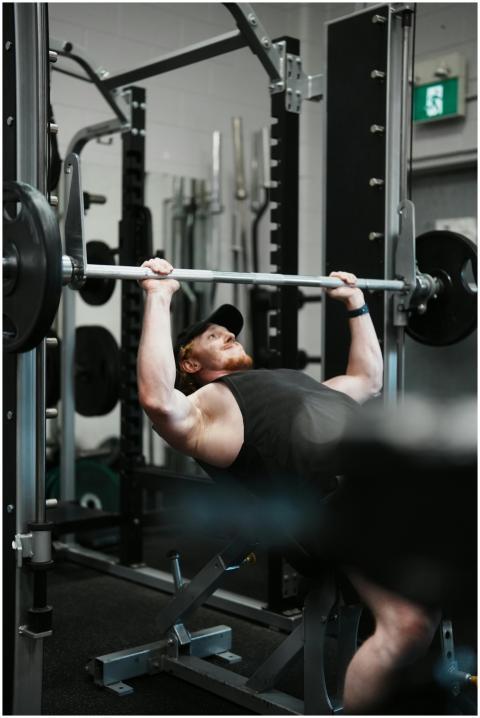Man Lifting Weights Incline