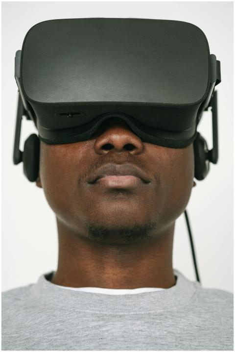 Close-up of a man wearing VR glasses, focused on v