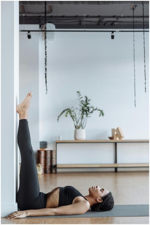 Woman practicing a relaxing yoga pose at home focu