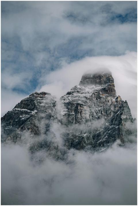 A striking image of a mountain peak shrouded in fo